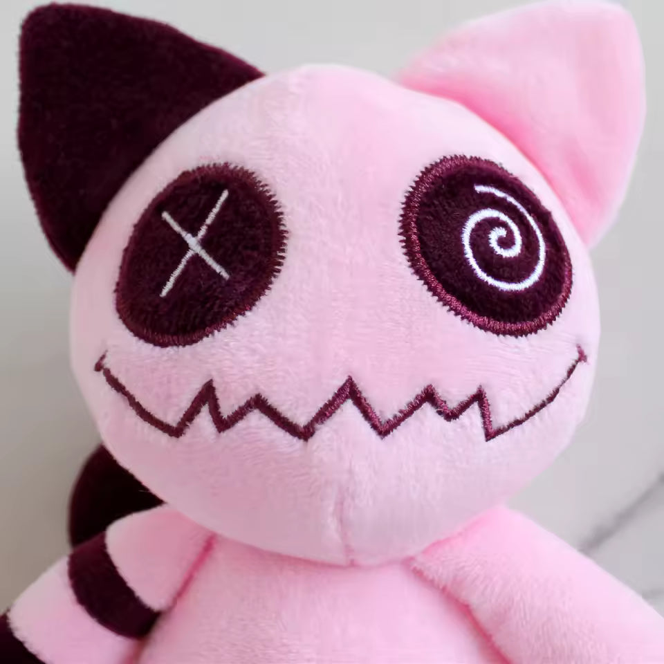 Plush toy with pink and black design on a plain background