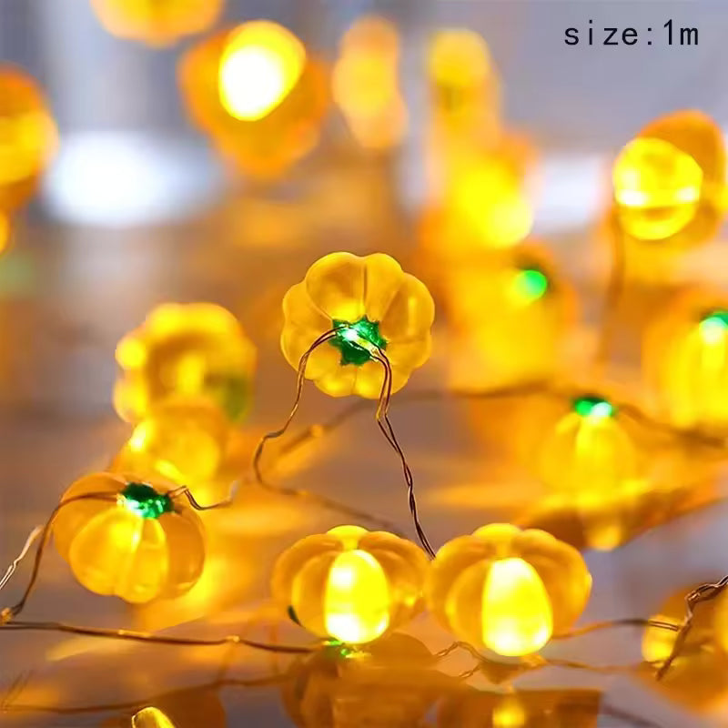 String of yellow pumpkin-shaped lights with a blurred background
