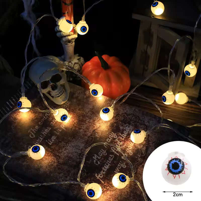 Halloween-themed string lights with eye design on a dark background