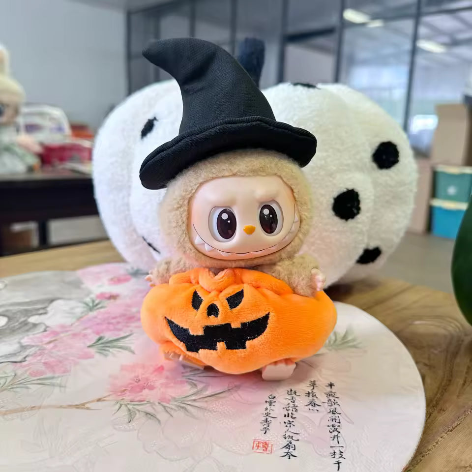 Toy character with a witch hat and pumpkin on a decorative surface
