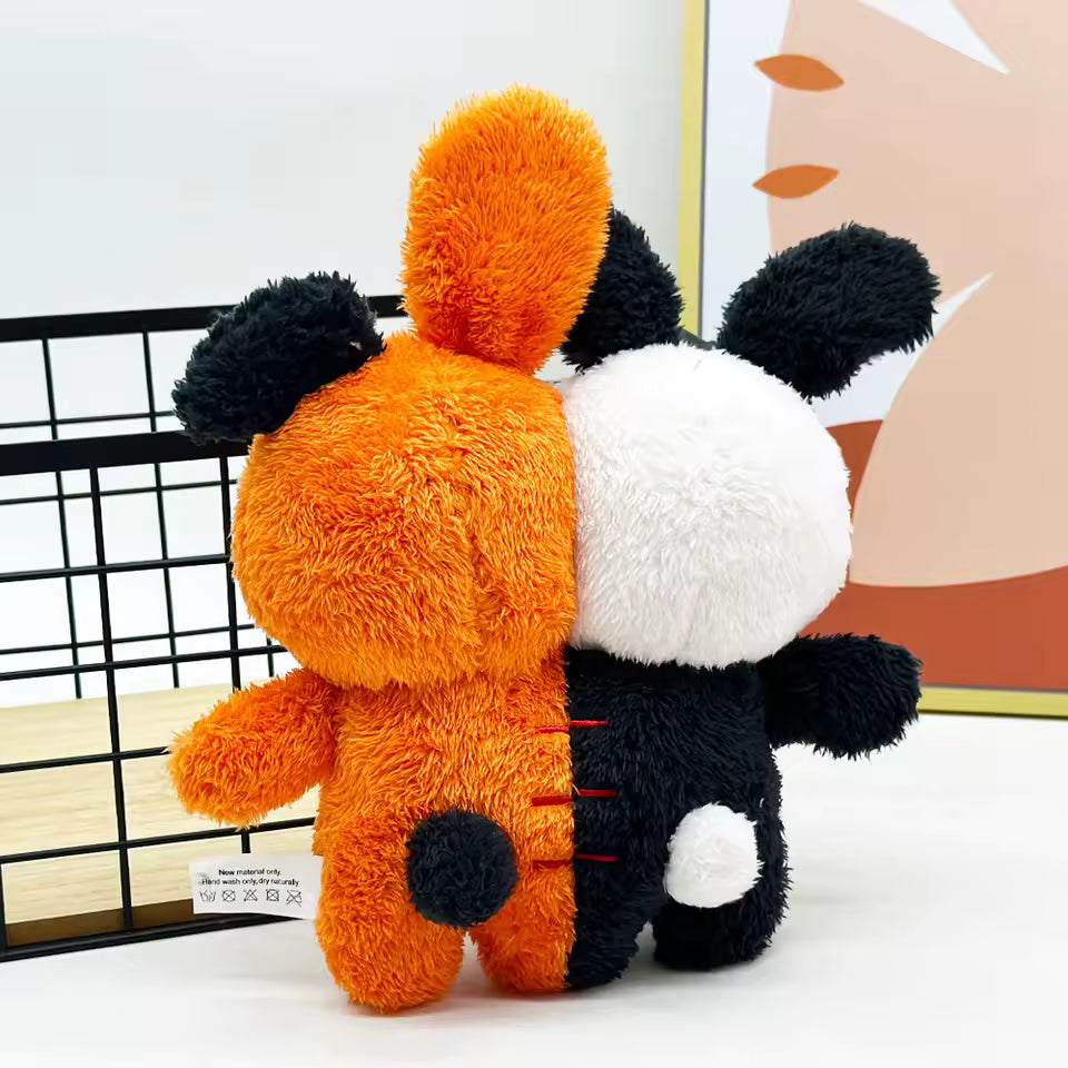 Plush toy with orange, black, and white sections on a white background