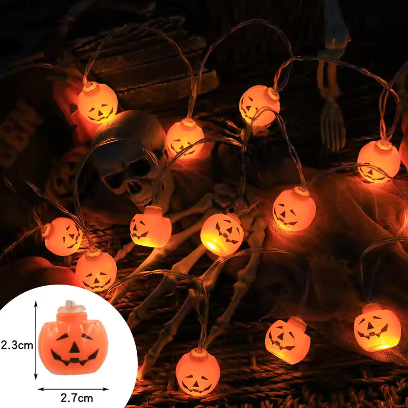 Halloween-themed string lights with jack-o'-lantern design on a dark background.