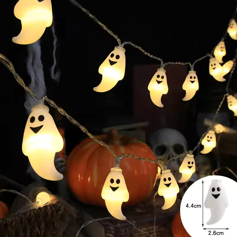Halloween-themed string lights with ghost-shaped bulbs on a dark background.