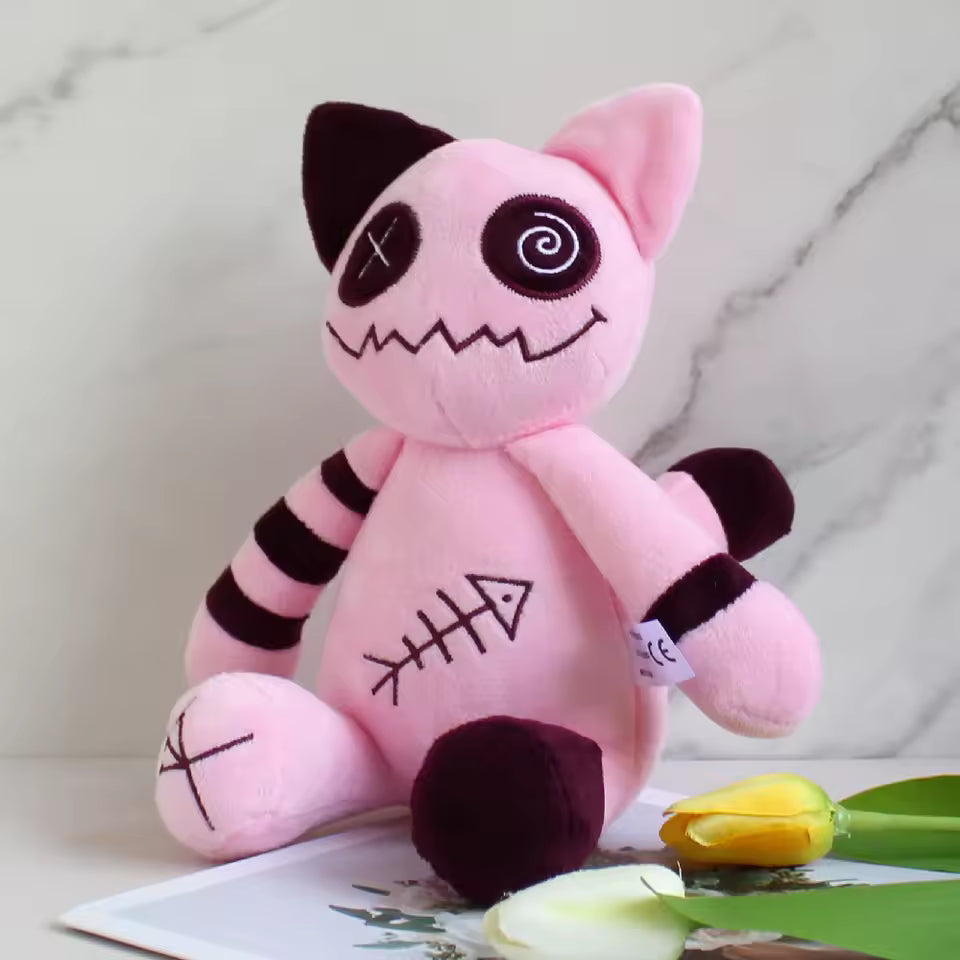 Pink plush toy with black accents on a marble surface with flowers