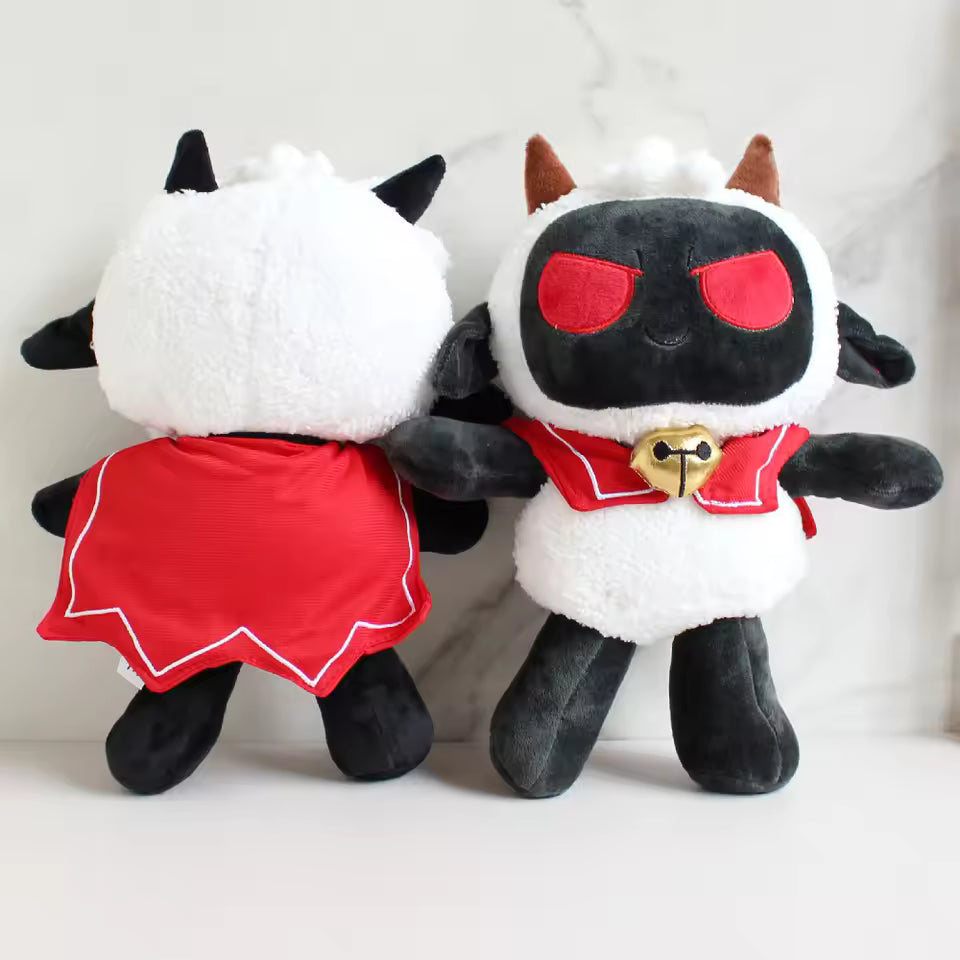 Two plush toys resembling black and white creatures with red dresses on a light background