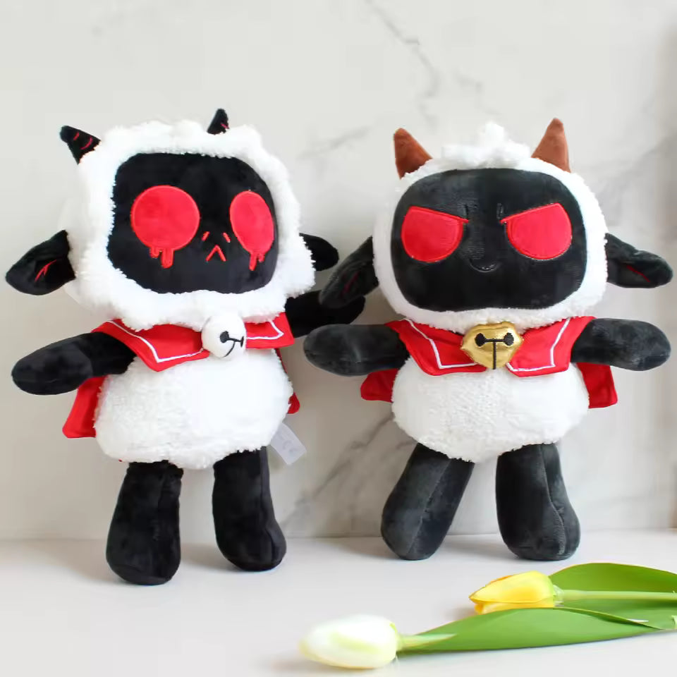 Two plush toys with black and white designs and red accents on a light background.